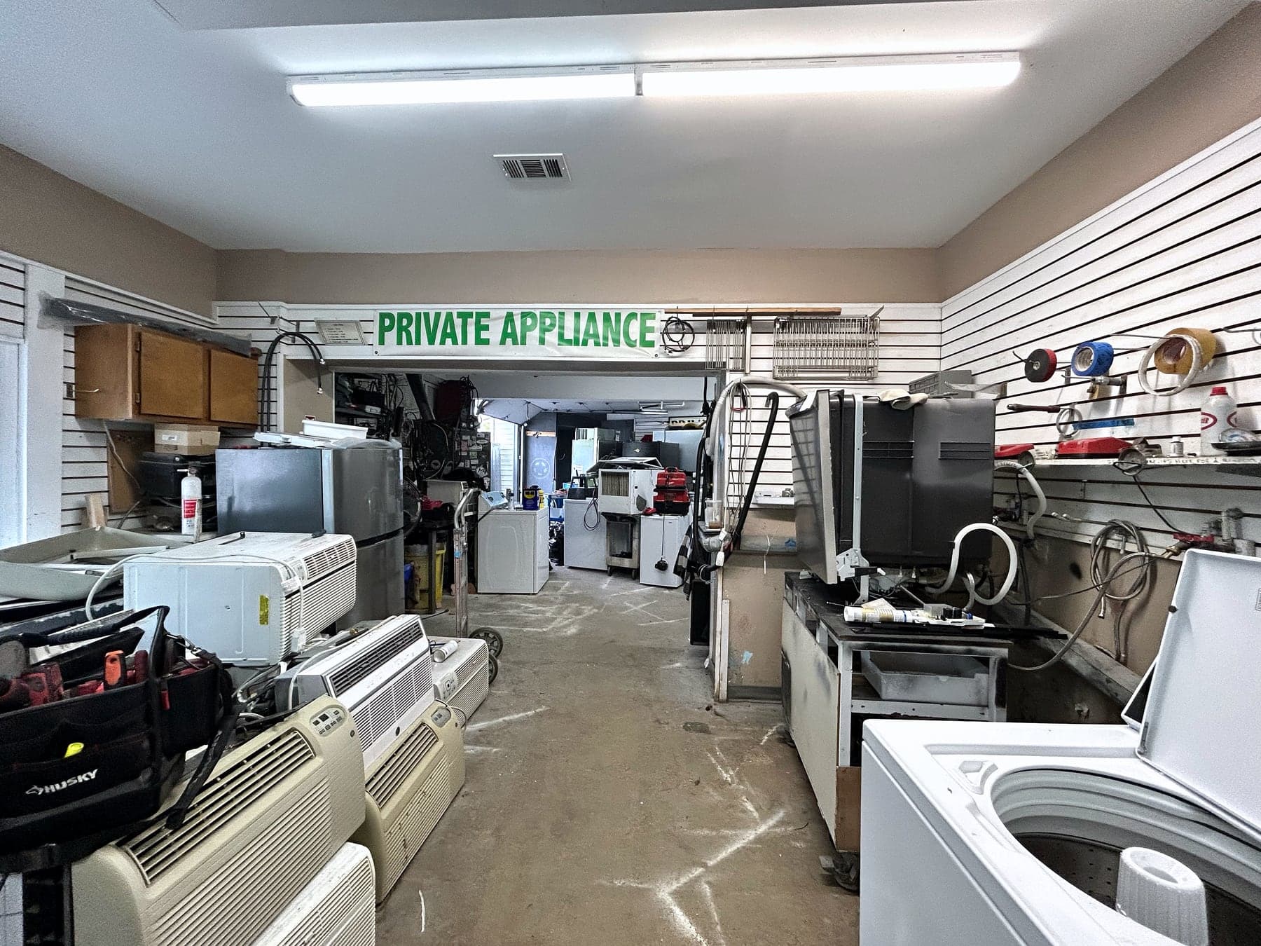 The Private Appliance service bay and repair bench behind the showroom